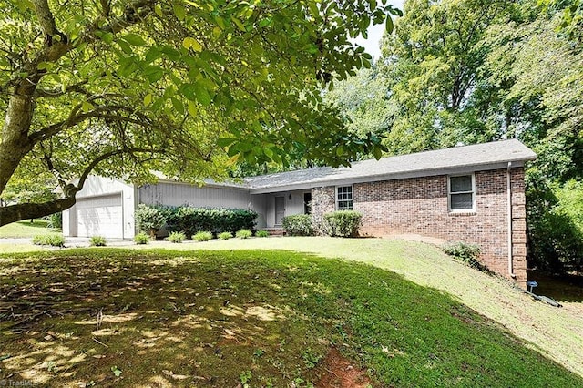 ranch-style house featuring a front yard and a garage