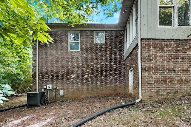 rear view of house featuring central AC