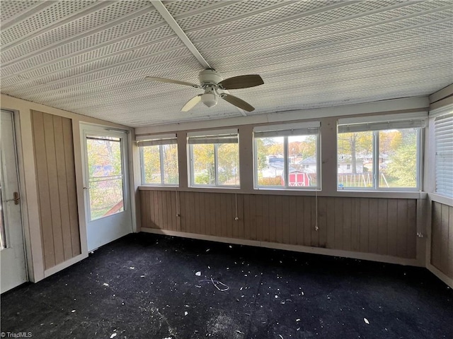 unfurnished sunroom with ceiling fan