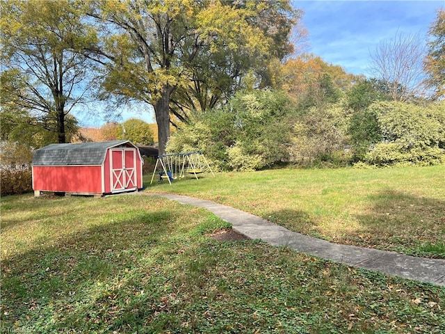 view of yard with a playground and a storage shed