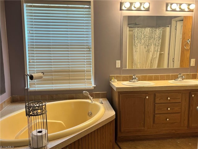 bathroom with vanity and a tub