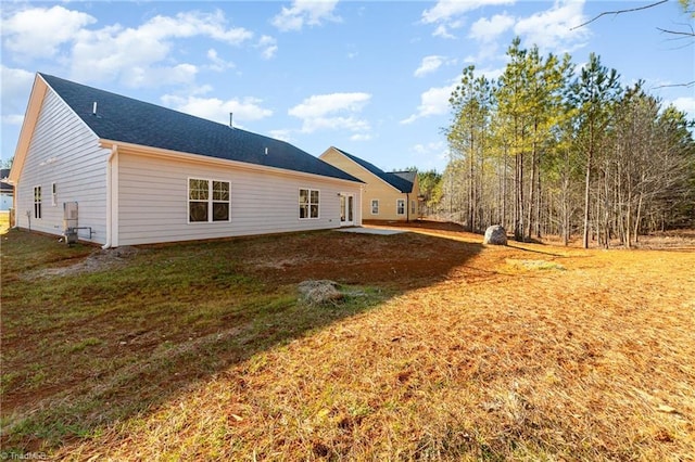 rear view of property with a lawn