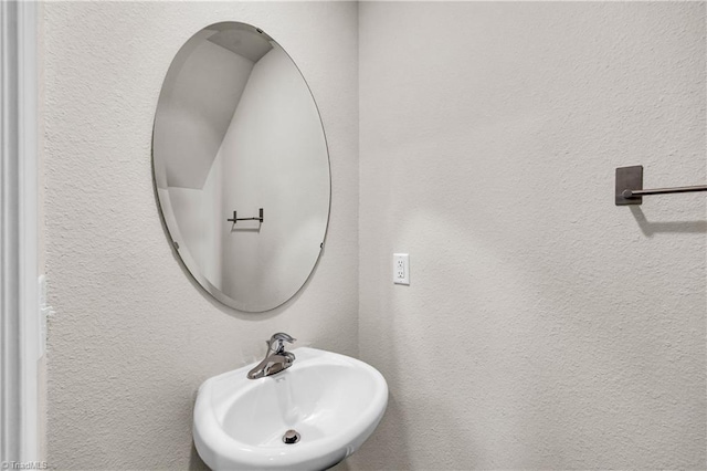 bathroom with a sink and a textured wall