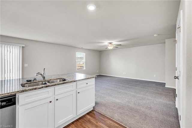 kitchen with light stone counters, ceiling fan, a sink, white cabinets, and dishwasher