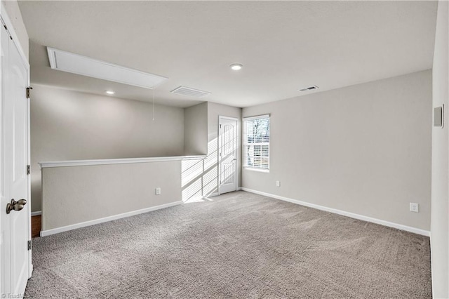 carpeted spare room with attic access, recessed lighting, visible vents, and baseboards