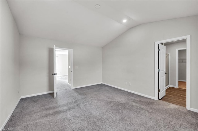 interior space featuring vaulted ceiling, recessed lighting, and baseboards