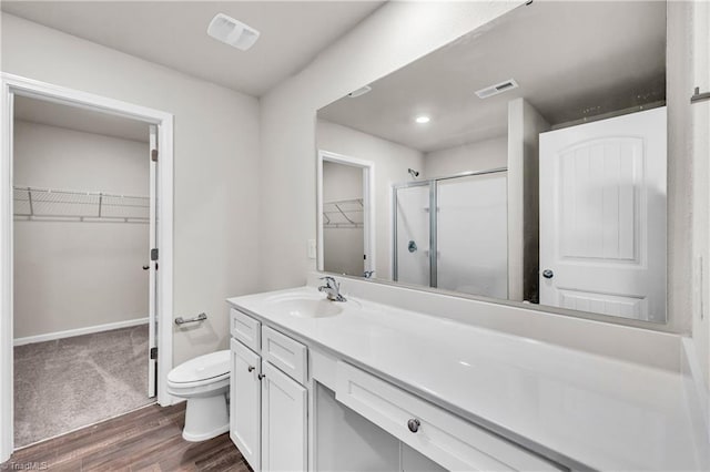 full bath with visible vents, toilet, a stall shower, and vanity