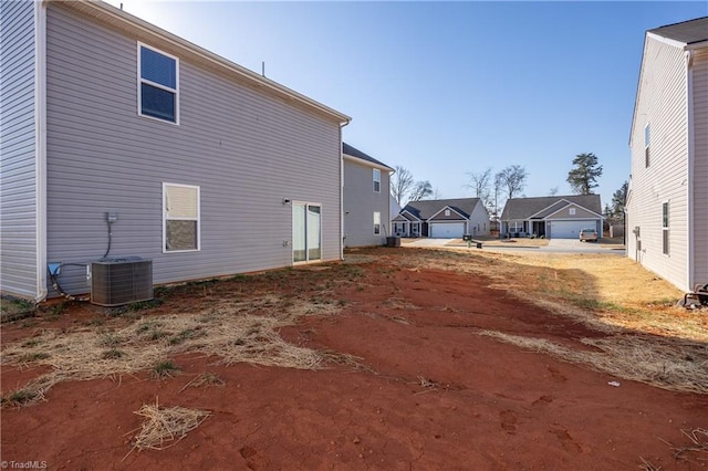 rear view of property with central AC