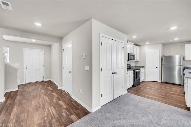 kitchen featuring visible vents, dark wood finished floors, white cabinetry, recessed lighting, and stainless steel appliances