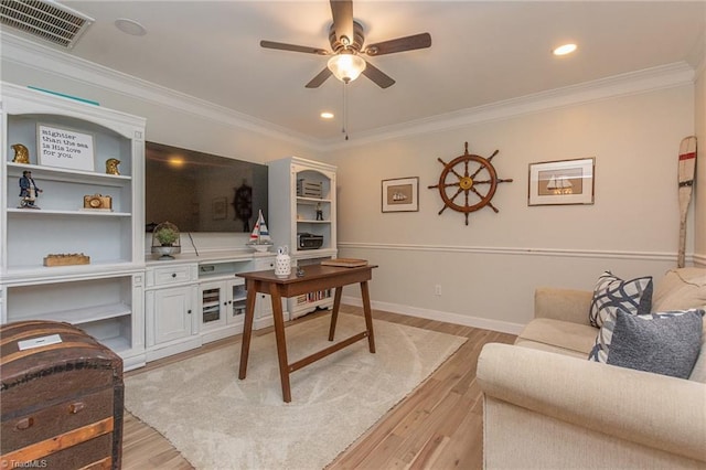 office featuring light hardwood / wood-style floors, ceiling fan, and ornamental molding