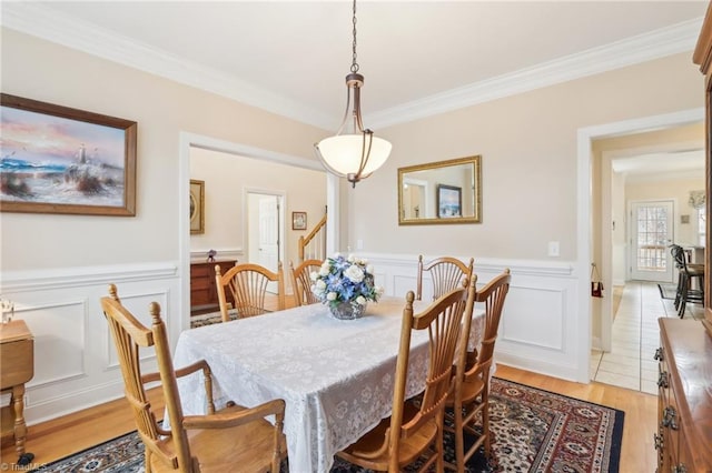 100 Wentworth Dr, Winston-Salem, NC 27107 - dining area with crown molding, light wood-style flooring, a decorative wall, and a wainscoted wall