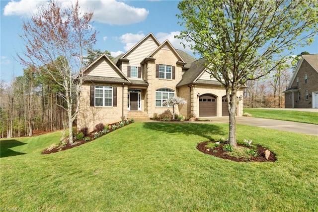 100 Wentworth Dr, Winston-Salem, NC 27107 - view of front facade featuring brick siding, an attached garage, concrete driveway, and a front lawn