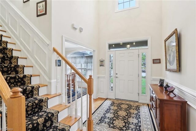 100 Wentworth Dr, Winston-Salem, NC 27107 - foyer entrance with a wainscoted wall, a healthy amount of sunlight, and stairway