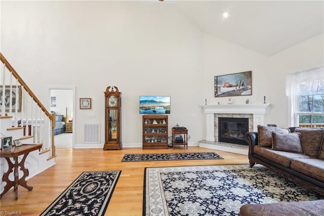 100 Wentworth Dr, Winston-Salem, NC 27107 - living room featuring visible vents, stairway, high vaulted ceiling, and wood finished floors