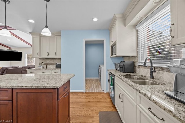 1941 Larkhill Dr, Kernersville, NC 27284 - kitchen with decorative backsplash, light wood-type flooring, decorative light fixtures, brown cabinets, and white cabinets