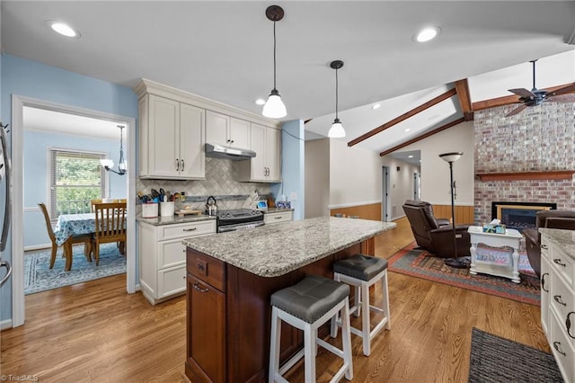 1941 Larkhill Dr, Kernersville, NC 27284 - kitchen featuring range with electric stovetop, light wood finished floors, white cabinets, a center island, and open floor plan