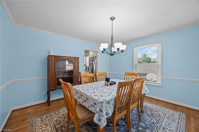 1941 Larkhill Dr, Kernersville, NC 27284 - dining area featuring a chandelier, crown molding, and wood finished floors