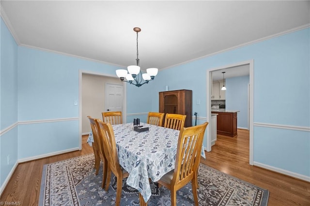1941 Larkhill Dr, Kernersville, NC 27284 - dining space featuring a chandelier, wood finished floors, and crown molding