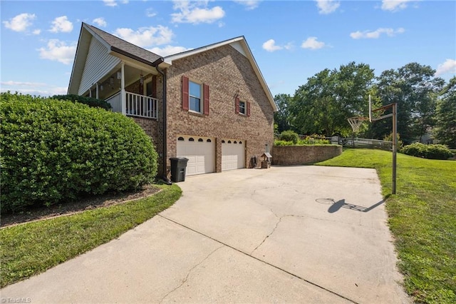 1941 Larkhill Dr, Kernersville, NC 27284 - view of side of property with brick siding, concrete driveway, a lawn, and an attached garage
