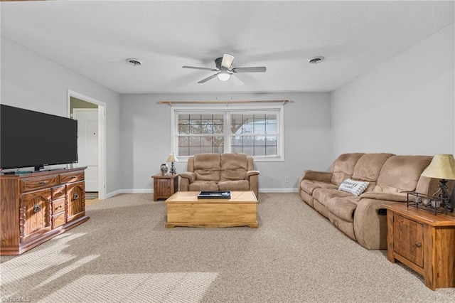 carpeted living room with ceiling fan