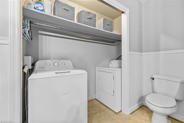 washroom with light tile patterned floors and washing machine and clothes dryer