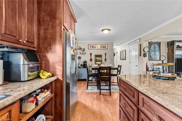 kitchen featuring stainless steel refrigerator with ice dispenser, light hardwood / wood-style floors, light stone counters, and ornamental molding