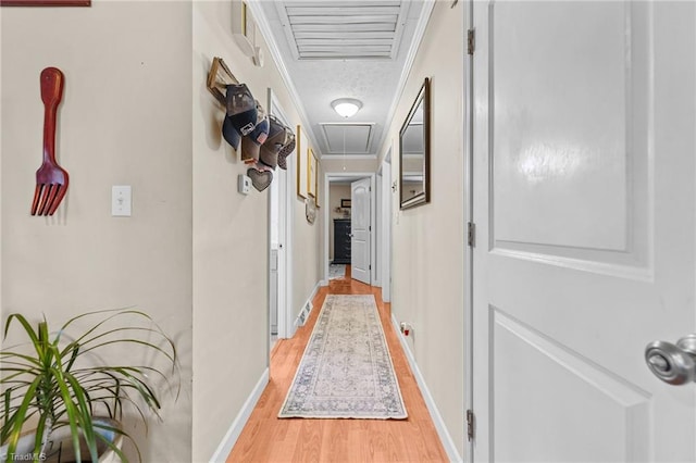 hallway with crown molding and light wood-type flooring