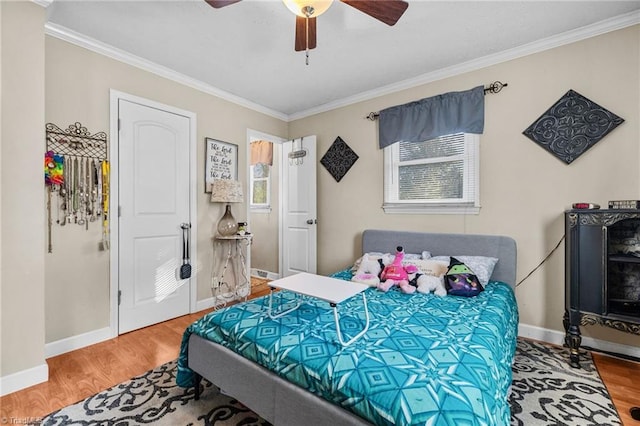 bedroom featuring ceiling fan, wood-type flooring, and ornamental molding