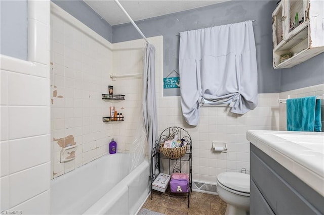 full bathroom featuring vanity, shower / bath combination with curtain, toilet, and tile walls