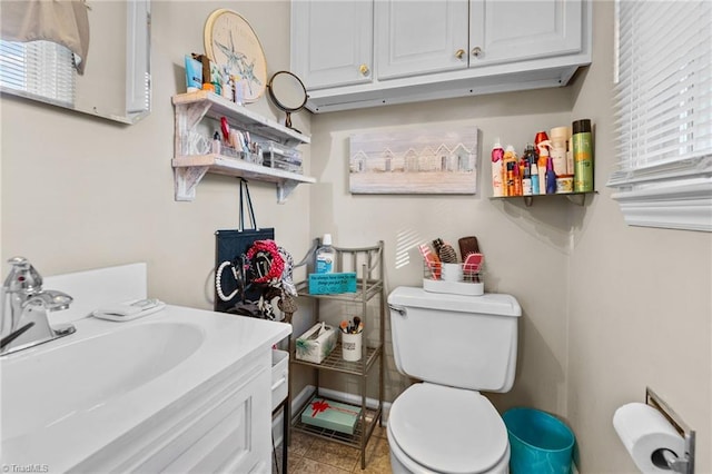 bathroom featuring tile patterned floors, vanity, and toilet