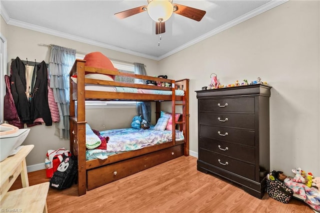 bedroom with hardwood / wood-style flooring, ceiling fan, and crown molding