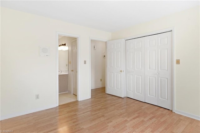 unfurnished bedroom with light hardwood / wood-style floors and a closet