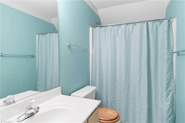 bathroom with a textured ceiling, vanity, curtained shower, and toilet