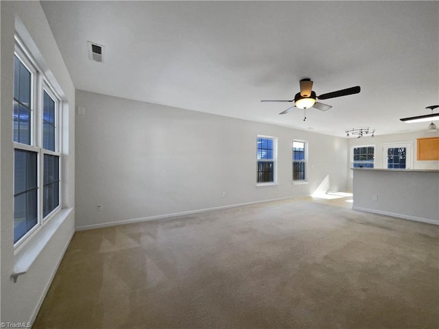 unfurnished living room with carpet floors and ceiling fan