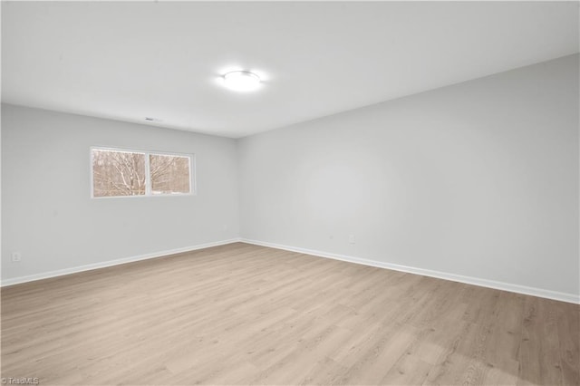 unfurnished room featuring light wood-style flooring and baseboards