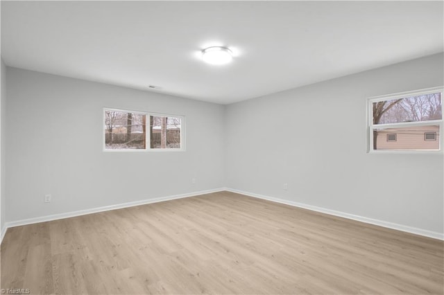 empty room featuring wood finished floors and baseboards