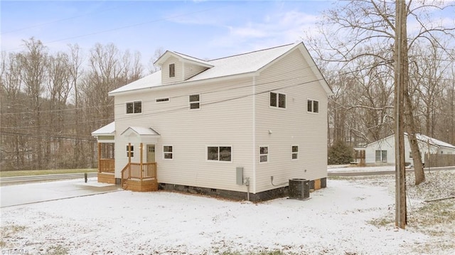 snow covered property with crawl space