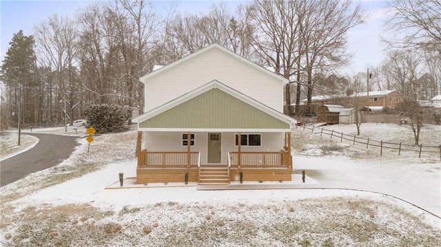 view of front facade featuring a porch and fence