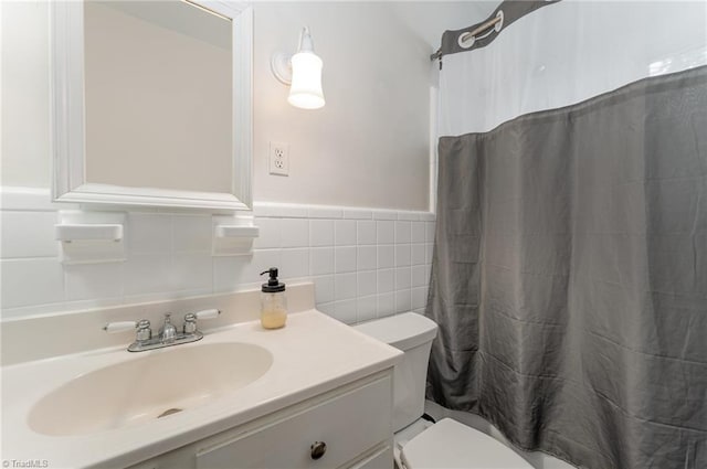 bathroom featuring vanity, tile walls, toilet, and a shower with shower curtain