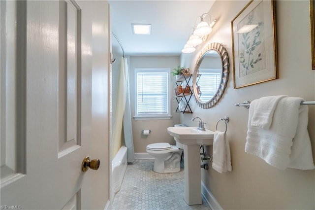 full bathroom featuring shower / bath combination with curtain, sink, toilet, and tile patterned flooring