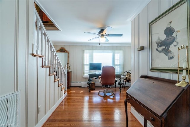 office area with wood-type flooring, ornamental molding, and ceiling fan