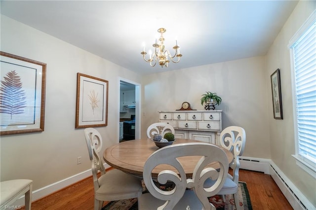 dining space featuring baseboard heating, dark wood-type flooring, and a notable chandelier