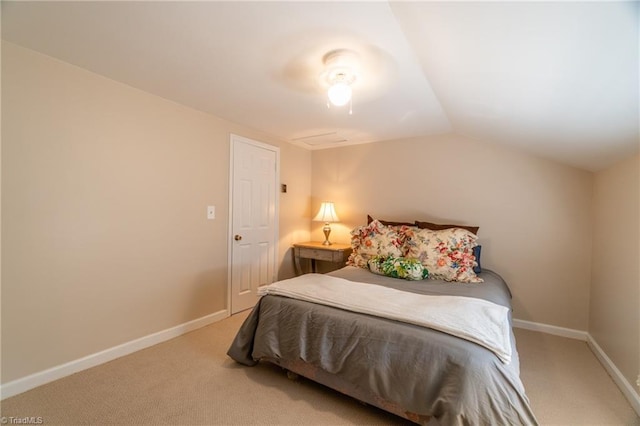 carpeted bedroom featuring lofted ceiling