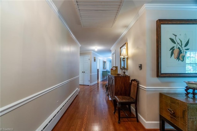 hall featuring a baseboard heating unit, ornamental molding, and dark hardwood / wood-style floors