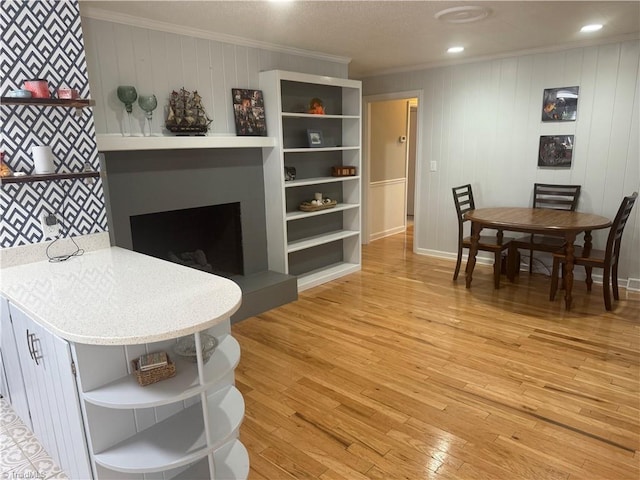 living room with crown molding and wood-type flooring