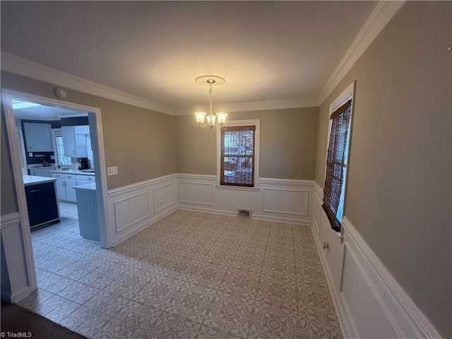 unfurnished dining area with ornamental molding and a notable chandelier