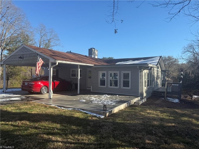 back of property featuring a yard and a carport