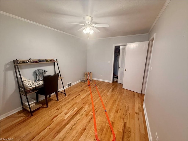 interior space featuring ceiling fan, crown molding, and hardwood / wood-style flooring