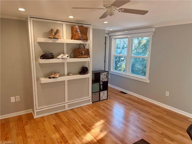 interior space with ceiling fan, light wood-type flooring, and crown molding