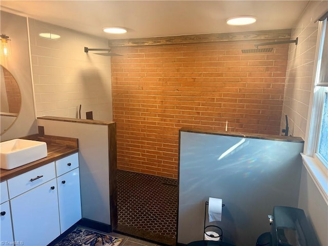 bathroom with vanity and tiled shower